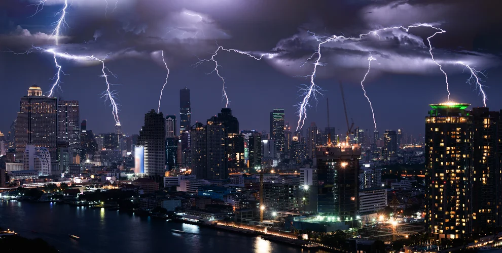 Lightning storm over city in purple light